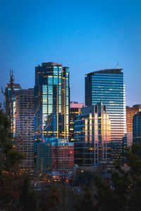 Preview wallpaper city, buildings, glass, reflection, trees