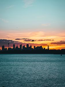 Preview wallpaper city, buildings, helicopter, coast, dusk, dark