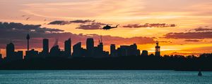 Preview wallpaper city, buildings, helicopter, coast, dusk, dark