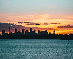 Preview wallpaper city, buildings, helicopter, coast, dusk, dark