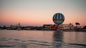 Preview wallpaper city, buildings, hot air balloon, water, waves, twilight