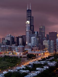 Preview wallpaper city, buildings, houses, roads, light, sky, storm, clouds, grass, trees