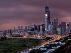 Preview wallpaper city, buildings, houses, roads, light, sky, storm, clouds, grass, trees