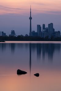 Preview wallpaper city, buildings, lake, water, reflection, dusk