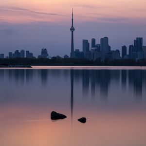 Preview wallpaper city, buildings, lake, water, reflection, dusk