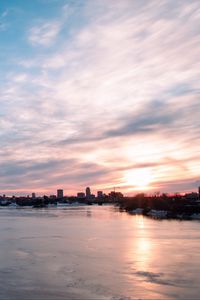 Preview wallpaper city, buildings, lake, ice, clouds, sunset