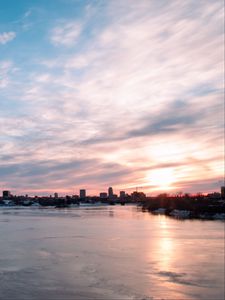 Preview wallpaper city, buildings, lake, ice, clouds, sunset