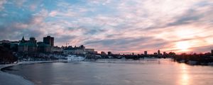 Preview wallpaper city, buildings, lake, ice, clouds, sunset