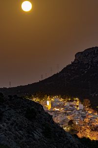 Preview wallpaper city, buildings, lights, mountains, moon, night