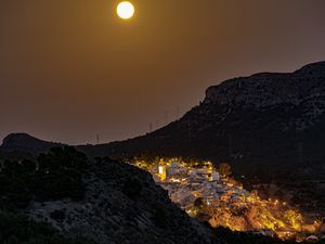 Preview wallpaper city, buildings, lights, mountains, moon, night