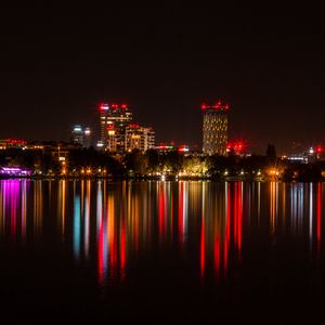 Preview wallpaper city, buildings, lights, glow, reflection