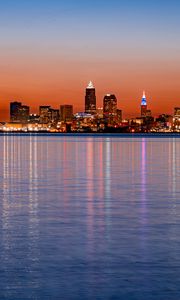 Preview wallpaper city, buildings, lights, water, reflection, sunset