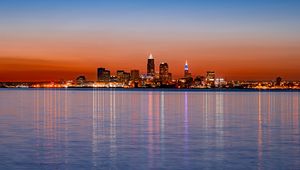 Preview wallpaper city, buildings, lights, water, reflection, sunset