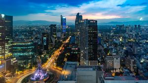 Preview wallpaper city, buildings, lights, road, twilight, aerial view