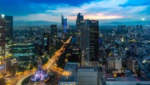 Preview wallpaper city, buildings, lights, road, twilight, aerial view