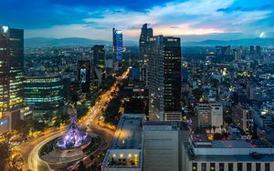 Preview wallpaper city, buildings, lights, road, twilight, aerial view