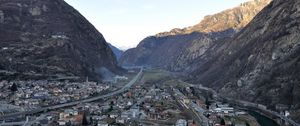 Preview wallpaper city, buildings, mountains, rocks, gorge, shadow