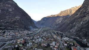 Preview wallpaper city, buildings, mountains, rocks, gorge, shadow