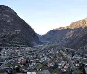 Preview wallpaper city, buildings, mountains, rocks, gorge, shadow