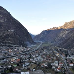 Preview wallpaper city, buildings, mountains, rocks, gorge, shadow