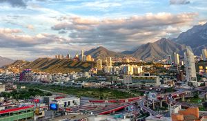 Preview wallpaper city, buildings, mountains, roads