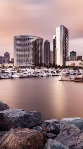 Preview wallpaper city, buildings, pier, boats, water, twilight