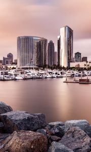 Preview wallpaper city, buildings, pier, boats, water, twilight