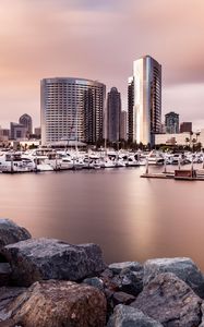 Preview wallpaper city, buildings, pier, boats, water, twilight