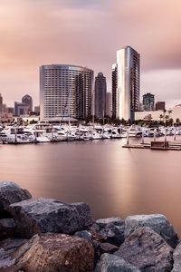 Preview wallpaper city, buildings, pier, boats, water, twilight