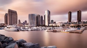 Preview wallpaper city, buildings, pier, boats, water, twilight