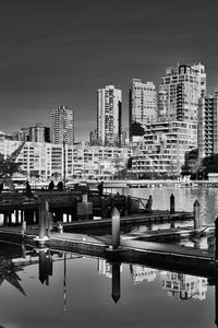 Preview wallpaper city, buildings, pier, black and white