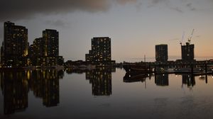 Preview wallpaper city, buildings, reflection, water, twilight