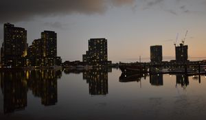 Preview wallpaper city, buildings, reflection, water, twilight