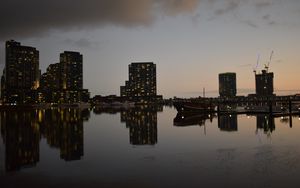 Preview wallpaper city, buildings, reflection, water, twilight