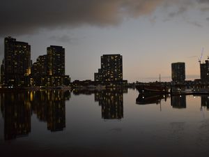 Preview wallpaper city, buildings, reflection, water, twilight