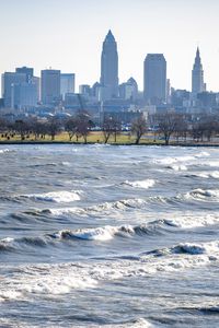 Preview wallpaper city, buildings, river, water, waves, trees