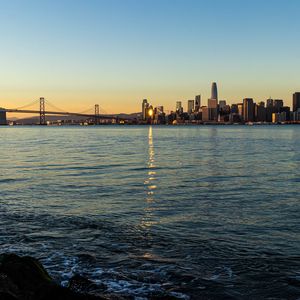 Preview wallpaper city, buildings, river, water, light, twilight