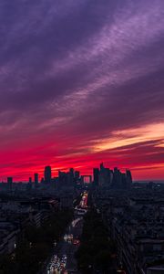 Preview wallpaper city, buildings, road, lights, sunset, evening