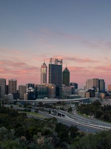 Preview wallpaper city, buildings, road, sunset