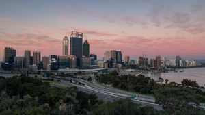 Preview wallpaper city, buildings, road, sunset
