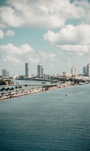 Preview wallpaper city, buildings, road, palm trees, boat, sea