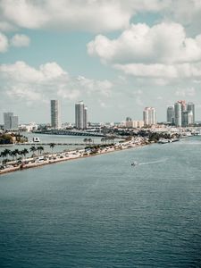 Preview wallpaper city, buildings, road, palm trees, boat, sea