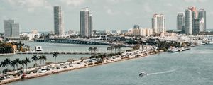 Preview wallpaper city, buildings, road, palm trees, boat, sea