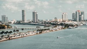 Preview wallpaper city, buildings, road, palm trees, boat, sea