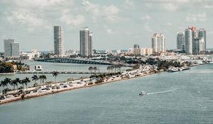 Preview wallpaper city, buildings, road, palm trees, boat, sea