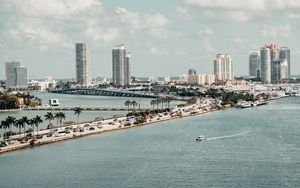 Preview wallpaper city, buildings, road, palm trees, boat, sea