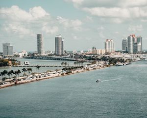 Preview wallpaper city, buildings, road, palm trees, boat, sea