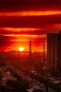 Preview wallpaper city, buildings, road, sun, sunset, dark
