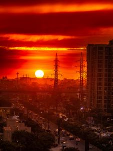 Preview wallpaper city, buildings, road, sun, sunset, dark