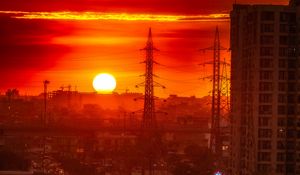 Preview wallpaper city, buildings, road, sun, sunset, dark